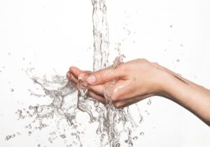 hand-feeling-the-temperature-of-running-water
