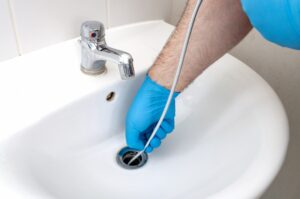 cleaning-bathroom-sink-drain-with-a-snake