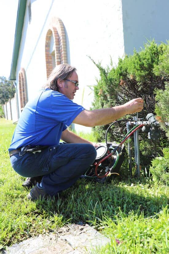 Technician performing a test on plumbing backflow