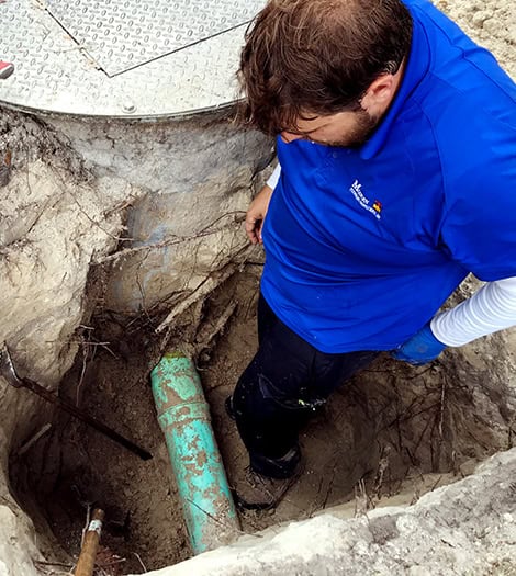 Technician performing a commercial plumbing repair