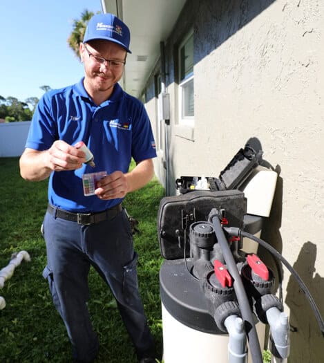 Technician performing a water quality test on water filtration system