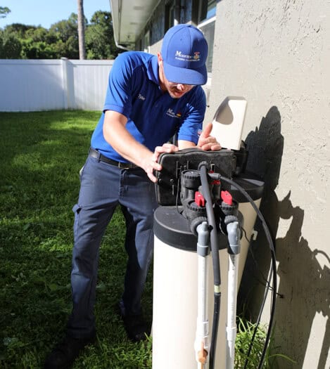 technician servicing a whole-house water filtration