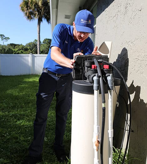 Technician repairing a water treatment system
